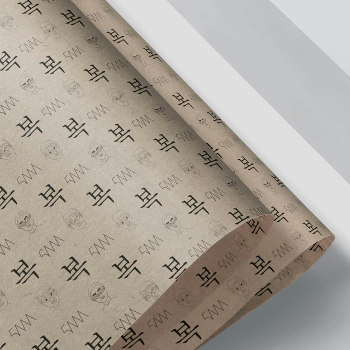 Mockup of wrapping paper which features a proprietary pattern of Shawn S. Chois monogram, caricature, and character/symbols.