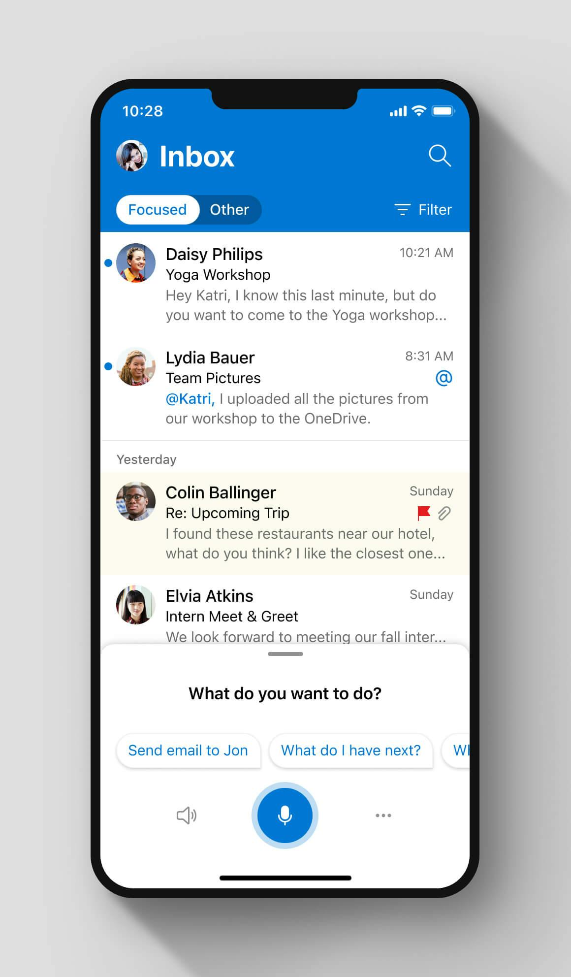 Email inbox on a Outlook Mobile application with a list of emails from different senders, each accompanied by their profile pictures. At the bottom, theres a voice assistant interface with tappable suggestions.